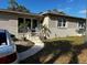 Single-story home featuring a combination of painted siding and brick accents with lush landscaping in the front yard at 5151 22Nd N Ave, St Petersburg, FL 33710
