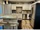 Modern kitchen with stainless steel appliances, white cabinets, butcher block countertops, and a kitchen island at 5151 22Nd N Ave, St Petersburg, FL 33710