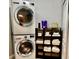 Convenient laundry room featuring a stacked washer and dryer and shelving for organization and storage at 5151 22Nd N Ave, St Petersburg, FL 33710