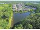 An aerial view of the townhomes with a beautiful lake and pool with treelined neighborhood streets at 5509 Cumberland Star Ct, Lutz, FL 33558