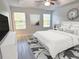 Bright, staged bedroom featuring neutral colors, a ceiling fan, and two windows for natural light at 5509 Cumberland Star Ct, Lutz, FL 33558