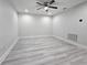 Empty bedroom features light gray wood-look flooring, ceiling fan, and recessed lighting at 5509 Cumberland Star Ct, Lutz, FL 33558