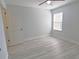 Bedroom featuring light gray floors, a ceiling fan, and a window providing natural light at 5509 Cumberland Star Ct, Lutz, FL 33558