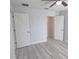 Bedroom featuring light gray floors, a ceiling fan, and access to a walk-in closet for storage at 5509 Cumberland Star Ct, Lutz, FL 33558