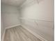 Walk-in closet featuring gray floors and wire shelving for optimal organization and storage solutions at 5509 Cumberland Star Ct, Lutz, FL 33558