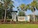 Elegant community entrance sign for Lakeshore Preserve surrounded by lush landscaping and palm trees at 5509 Cumberland Star Ct, Lutz, FL 33558