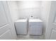 Laundry room with washer and dryer units, tiled floors, and wire shelving for storage at 5509 Cumberland Star Ct, Lutz, FL 33558