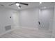 Neutral room with light gray wood-look floors, ceiling fan, and recessed lighting at 5509 Cumberland Star Ct, Lutz, FL 33558