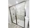 Modern walk-in shower with sleek glass doors, tiled walls, and contemporary fixtures at 5509 Cumberland Star Ct, Lutz, FL 33558