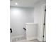 Brightly lit staircase with white walls and light-colored wood-look flooring at 5509 Cumberland Star Ct, Lutz, FL 33558