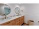 Bathroom featuring double sinks, modern fixtures, and a separate shower room at 6337 Cocoa Ln, Apollo Beach, FL 33572