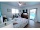 Bright bedroom with a workstation, backyard pool access, light walls, and modern ceiling fan at 6337 Cocoa Ln, Apollo Beach, FL 33572