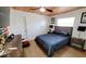 Bedroom with sleek ceiling fan, gray accent wall, and wood-look flooring, perfect for relaxing at 6337 Cocoa Ln, Apollo Beach, FL 33572