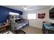 This bedroom features a bunk bed with a navy blue accent wall, offering a playful space at 6337 Cocoa Ln, Apollo Beach, FL 33572