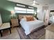 Bedroom features a king bed, an area rug and an entrance to an ensuite bathroom at 6337 Cocoa Ln, Apollo Beach, FL 33572