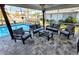 Relaxing outdoor seating on a private patio by the pool, perfect for entertaining guests at 6337 Cocoa Ln, Apollo Beach, FL 33572
