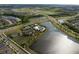 Aerial view of community with water features, tennis courts, and roadways at 6337 Shore Vista Pl, Apollo Beach, FL 33572