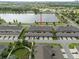 Aerial view displays garage parking, green spaces, landscaping, and street parking near the lake at 6337 Shore Vista Pl, Apollo Beach, FL 33572
