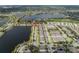 Wide aerial shot of lakeside community with well-maintained townhomes and lush surroundings at 6337 Shore Vista Pl, Apollo Beach, FL 33572