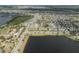 Community aerial view showcases lakeside homes near green spaces, landscaping and street parking at 6337 Shore Vista Pl, Apollo Beach, FL 33572