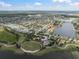 Community aerial view showcases lakeside homes and central park area with playground and walking paths at 6337 Shore Vista Pl, Apollo Beach, FL 33572