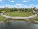 Scenic outdoor amphitheater with a wooden stage overlooking a tranquil pond surrounded by lush greenery at 6337 Shore Vista Pl, Apollo Beach, FL 33572