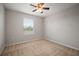 Bedroom with neutral carpet, ceiling fan, and window view at 6337 Shore Vista Pl, Apollo Beach, FL 33572