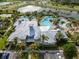 Overhead image capturing a community clubhouse alongside a luxurious pool and palm trees at 6337 Shore Vista Pl, Apollo Beach, FL 33572