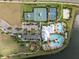 Aerial view of a community center with pools, sports courts, and a playground, providing diverse recreational options at 6337 Shore Vista Pl, Apollo Beach, FL 33572