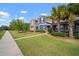 Neighborhood street with sidewalks lined with beautiful green lawns and decorative landscaping, enhancing curb appeal at 6337 Shore Vista Pl, Apollo Beach, FL 33572