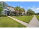 Charming townhome featuring a well-manicured lawn, lush landscaping, and a welcoming entrance at 6337 Shore Vista Pl, Apollo Beach, FL 33572