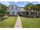 Charming townhouse featuring a manicured lawn, tasteful landscaping, and classic shutters, inviting curb appeal at 6337 Shore Vista Pl, Apollo Beach, FL 33572