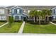 Charming townhouse featuring a manicured lawn, tasteful landscaping, and classic shutters, inviting curb appeal at 6337 Shore Vista Pl, Apollo Beach, FL 33572