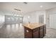 A modern kitchen with a center island, granite countertops, and stainless steel appliances at 6337 Shore Vista Pl, Apollo Beach, FL 33572