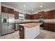A modern kitchen with a center island, granite countertops, and stainless steel appliances at 6337 Shore Vista Pl, Apollo Beach, FL 33572