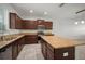 A modern kitchen with a center island, granite countertops, and stainless steel appliances at 6337 Shore Vista Pl, Apollo Beach, FL 33572