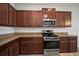 The kitchen features granite countertops, stainless steel appliances, and plentiful cabinet storage at 6337 Shore Vista Pl, Apollo Beach, FL 33572