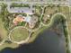 Aerial view of a park with playground, grassy areas, walking paths, and a serene pond at 6337 Shore Vista Pl, Apollo Beach, FL 33572
