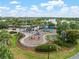 Aerial view of a vibrant community playground with modern equipment and shaded seating areas at 6337 Shore Vista Pl, Apollo Beach, FL 33572
