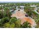 Attractive splash pad surrounded by lush landscaping, lounge chairs and shaded seating, perfect for Gathering fun at 6337 Shore Vista Pl, Apollo Beach, FL 33572