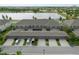 Aerial view of townhomes with garages, parking and scenic lake in the backdrop at 6337 Shore Vista Pl, Apollo Beach, FL 33572