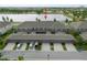 Aerial view of townhomes with garages, parking and scenic lake in the backdrop at 6337 Shore Vista Pl, Apollo Beach, FL 33572