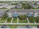 Areal view of townhome with well-manicured lawns, mature trees, and convenient parking at 6337 Shore Vista Pl, Apollo Beach, FL 33572