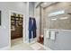 Bright bathroom featuring a glass-enclosed shower, and adjacent walk-in closet at 7209 Meeting House Ln, Apollo Beach, FL 33572