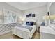 Comfortable bedroom featuring white furniture, a cozy bed and bright windows at 7209 Meeting House Ln, Apollo Beach, FL 33572