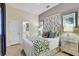 Well-lit bedroom with a decorative headboard and ensuite bathroom view at 7209 Meeting House Ln, Apollo Beach, FL 33572