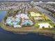 A bird's eye view of the community amenities including a pool, sports courts, and lush landscaping at 7209 Meeting House Ln, Apollo Beach, FL 33572