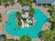 Aerial view of a fun swimming pool with water slides and lounge chairs for residents enjoyment at 7209 Meeting House Ln, Apollo Beach, FL 33572