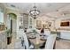 Formal dining room boasts a modern chandelier and access to the open living area at 7209 Meeting House Ln, Apollo Beach, FL 33572