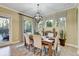 Dining room showcases a wood table, six chairs, decorative plants, and natural light at 7209 Meeting House Ln, Apollo Beach, FL 33572